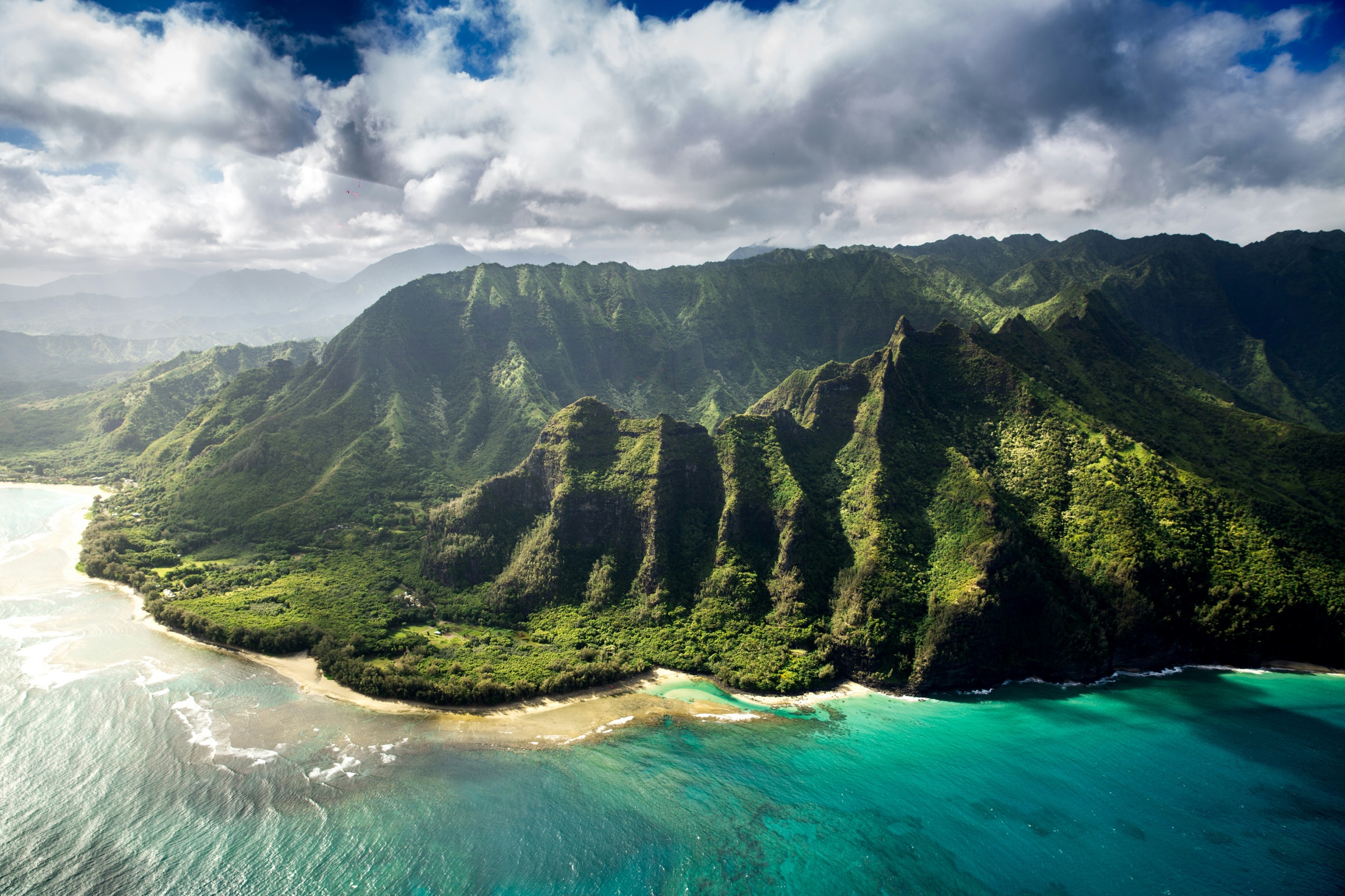 The lush green mountains and turquoise coastline of Hawaii