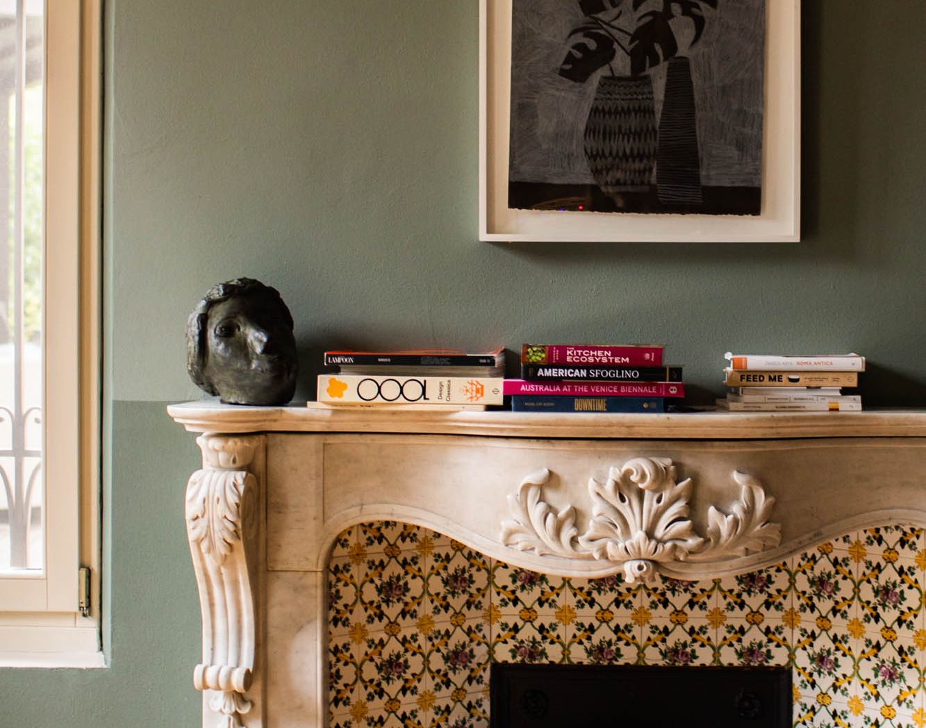 Art, books and an ornate fireplace at Casa Maria Luigia